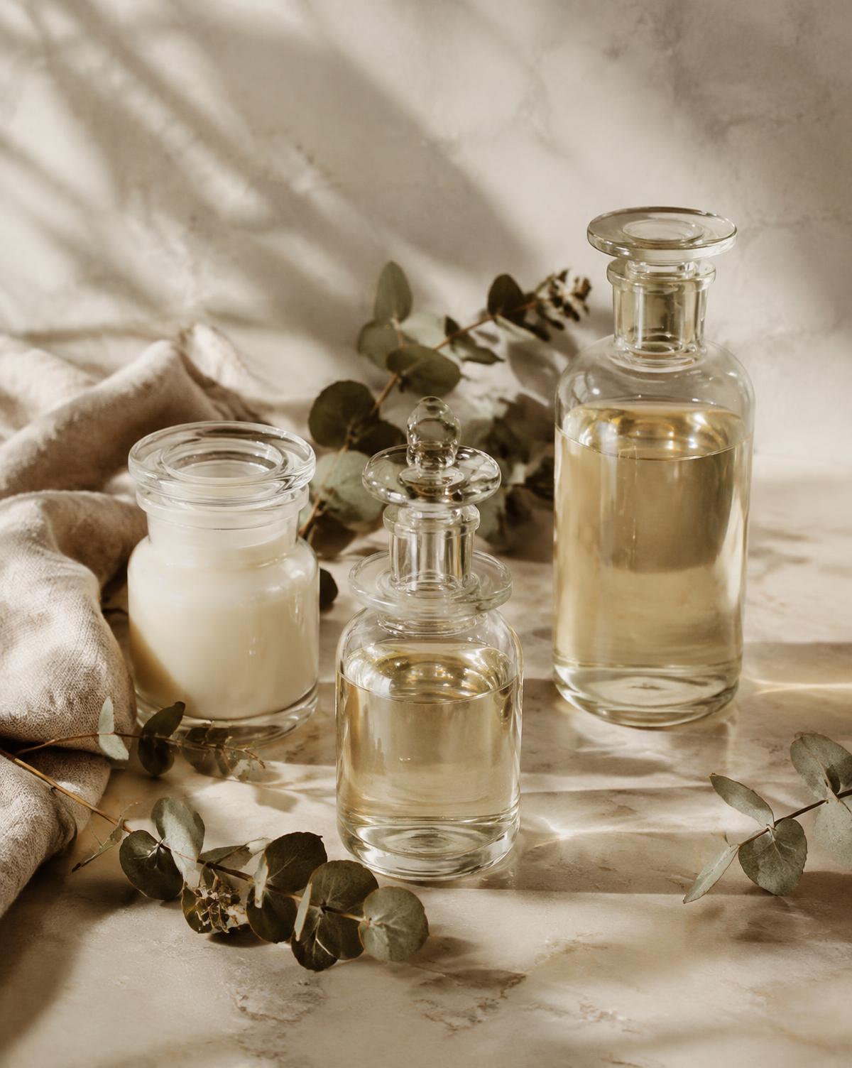 Glass apothecary vessels with eucalyptus on ivory marble
